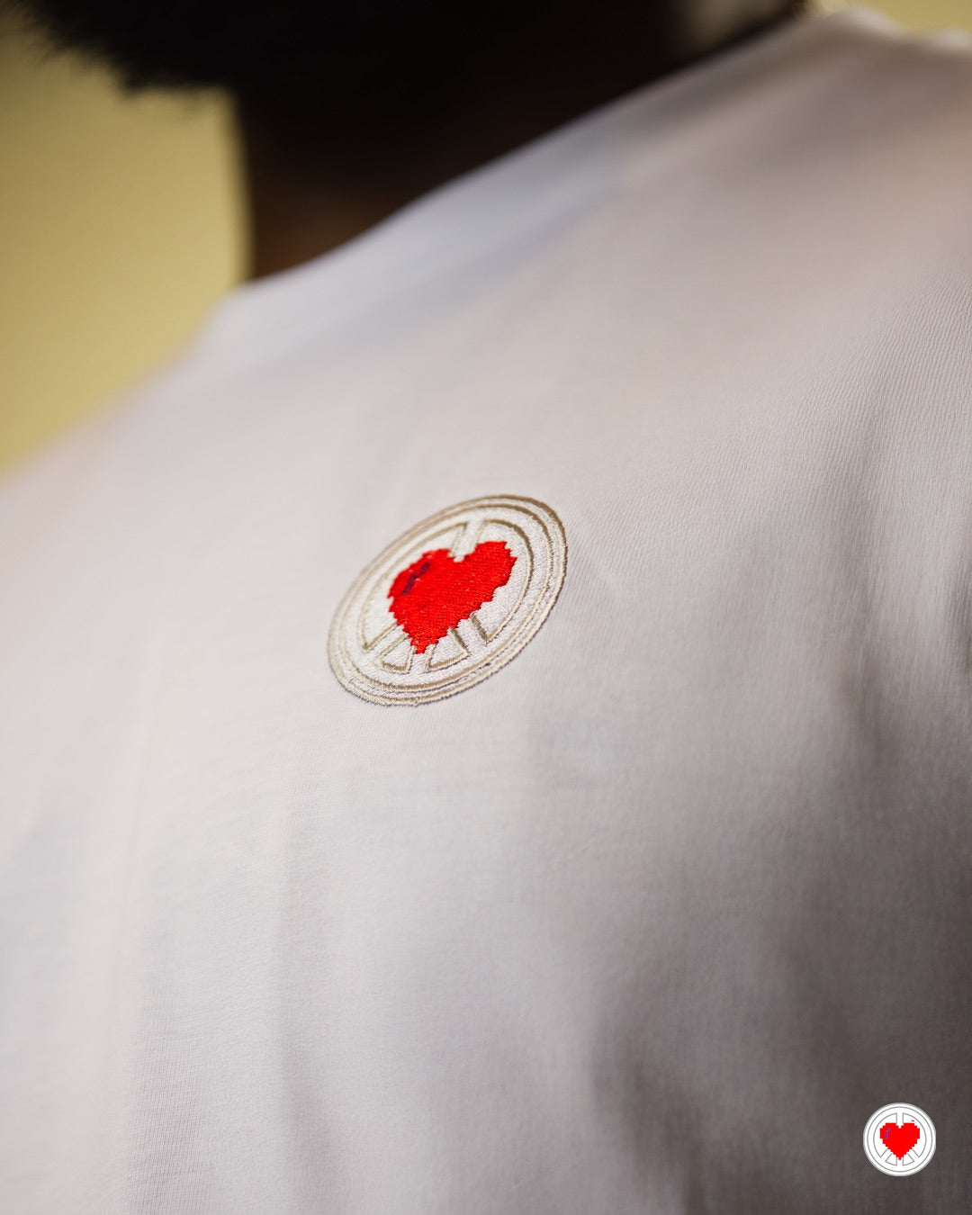 “Unisex White Stitched Heart Logo Tee”