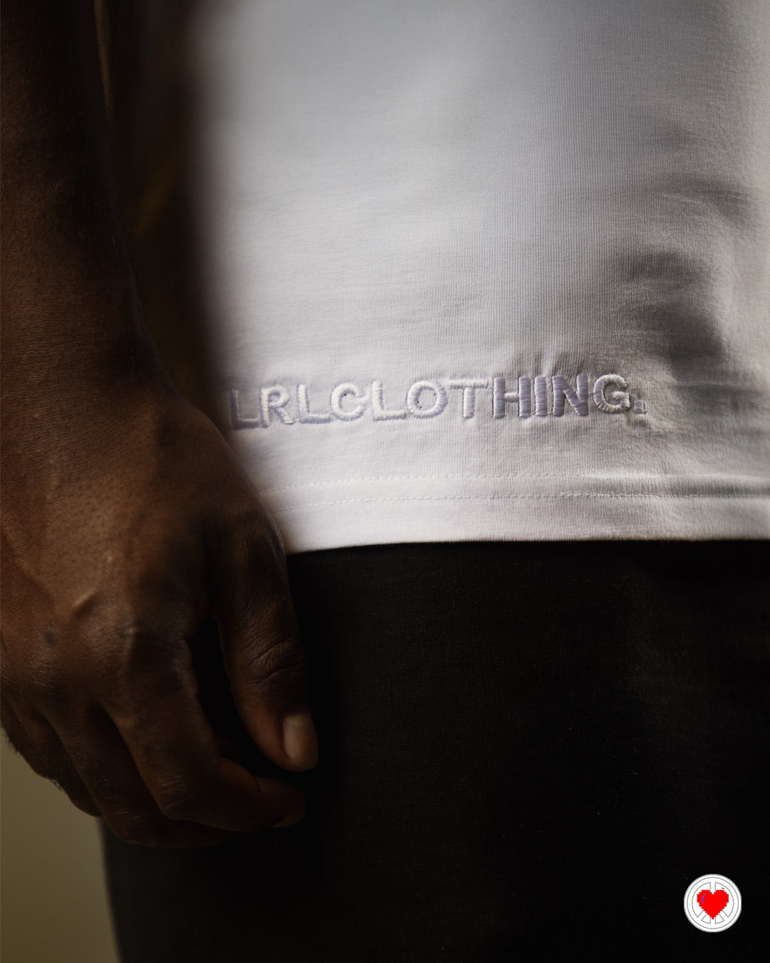 “Unisex White Stitched Heart Logo Tee”