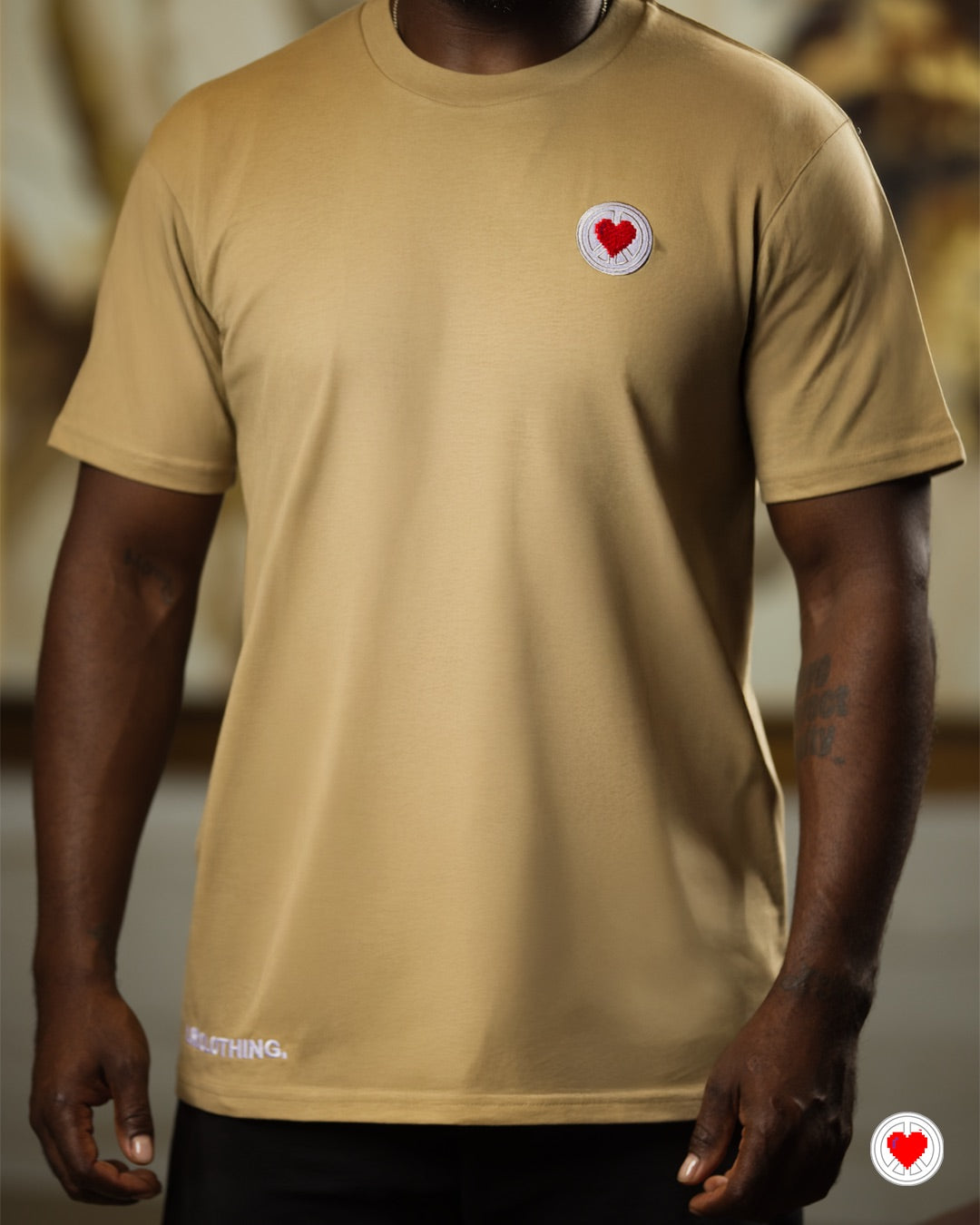 “Unisex Tan Stitched Heart Logo Tee”