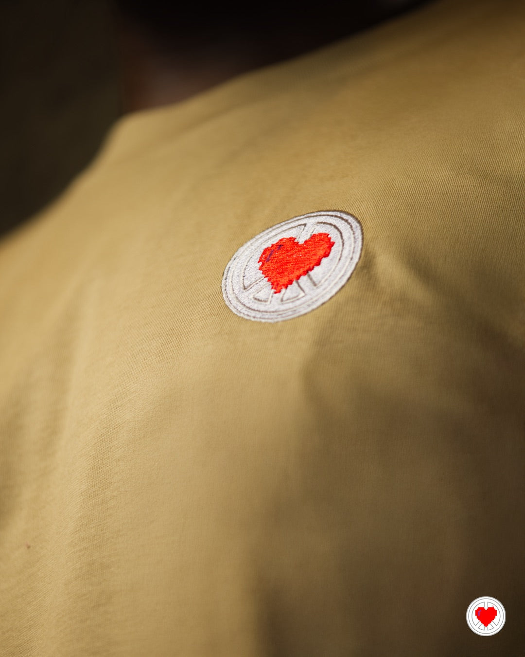 “Unisex Tan Stitched Heart Logo Tee”